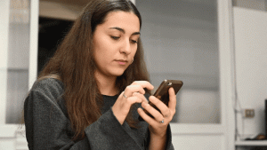 Woman scrolling her notifications created by Laundry Lane Productions